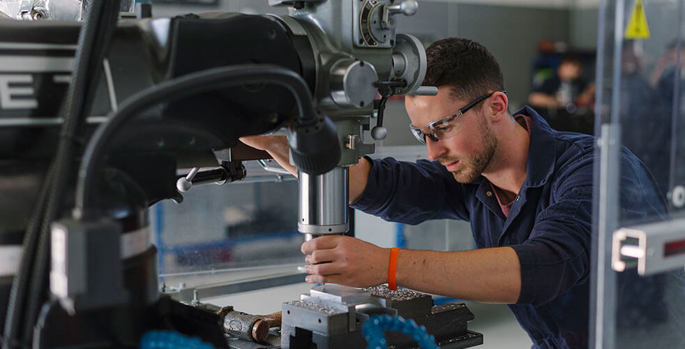 A student using engineering machinery at the Technology Centre