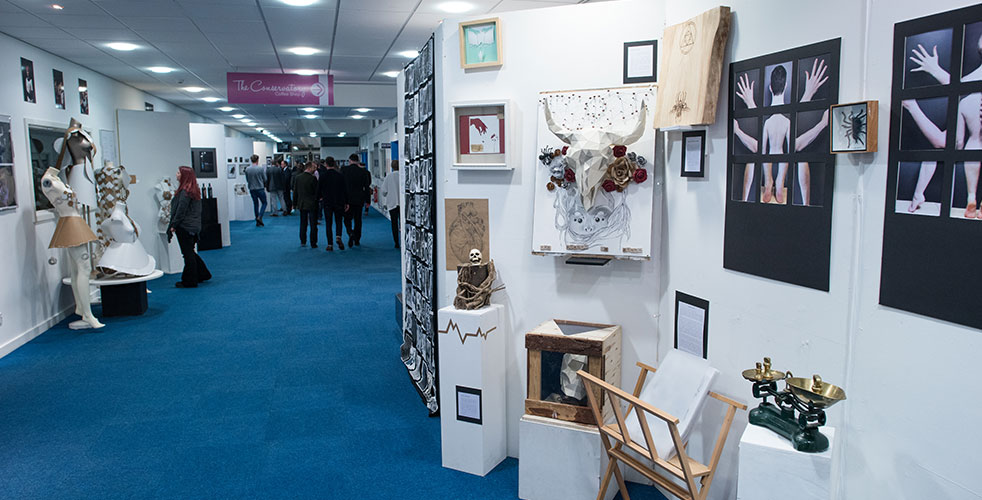 The Yard Gallery hallway with artwork on display with spectators