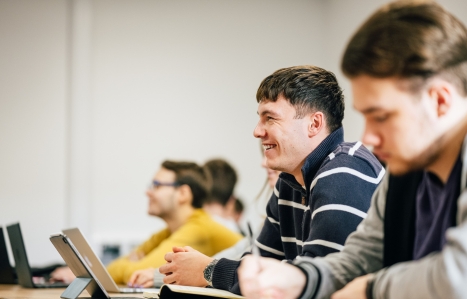 Access to Business student smiling in class