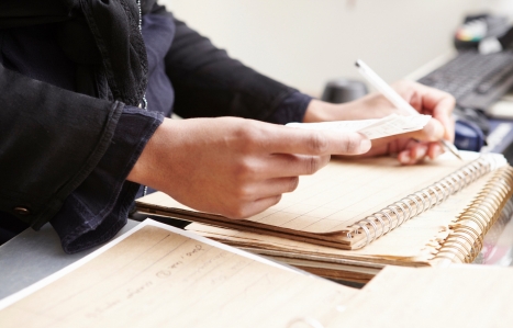 Close up of hands with notes and accountancy paperwork