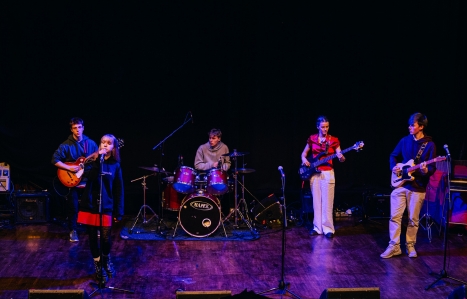 Four music students performing on stage