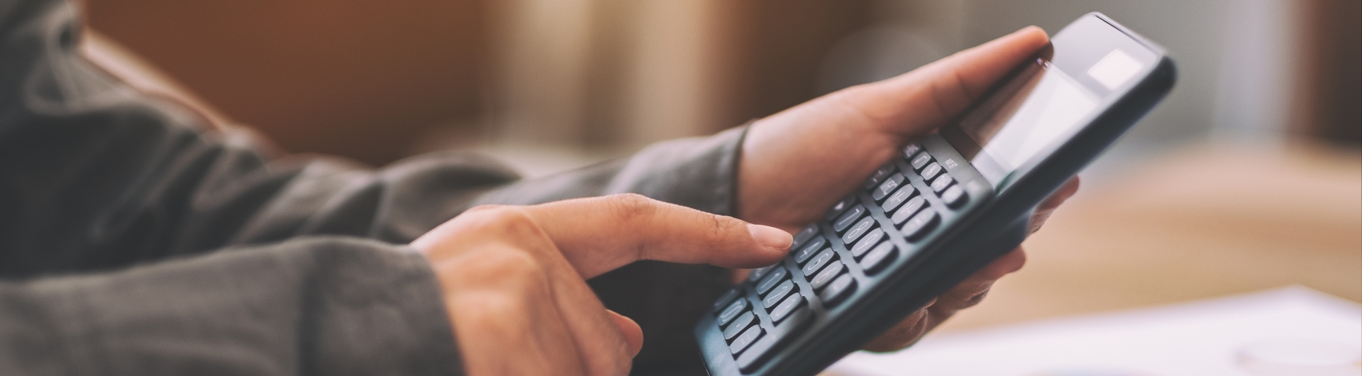 closeup-image-of-a-businessman-using-calculator