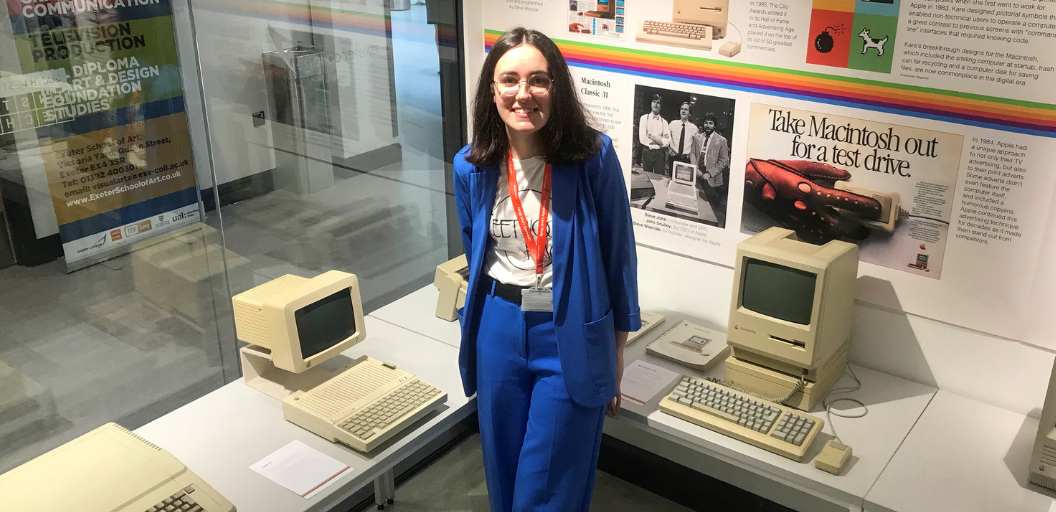 Exeter College student Sophie Bruce poses with old Apple Mac computers at the Mac Museum exhibit, located in the Exeter College Institute of Technology Digital and Data Centre.