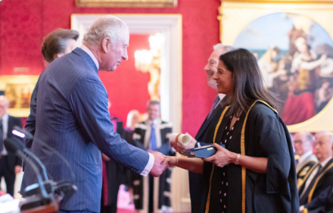 His Royal Highness the Prince of Wales presenting Bindu Arjoon, Chair of Governors at Exeter College, with a Queen's Anniversary Prize.
