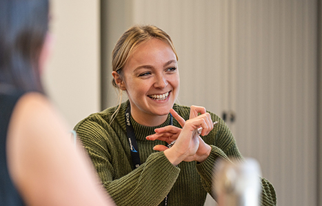 Smiling female adult student a green jumper