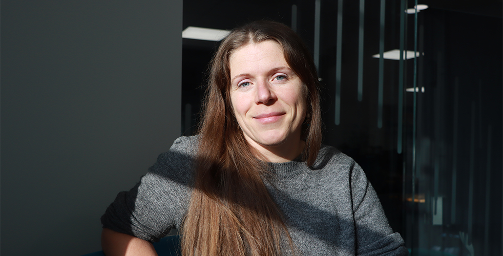 Portrait of women smiling at the camera in a grey jumper