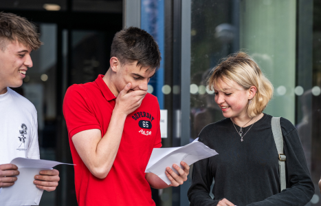 A student opens his results and smiles
