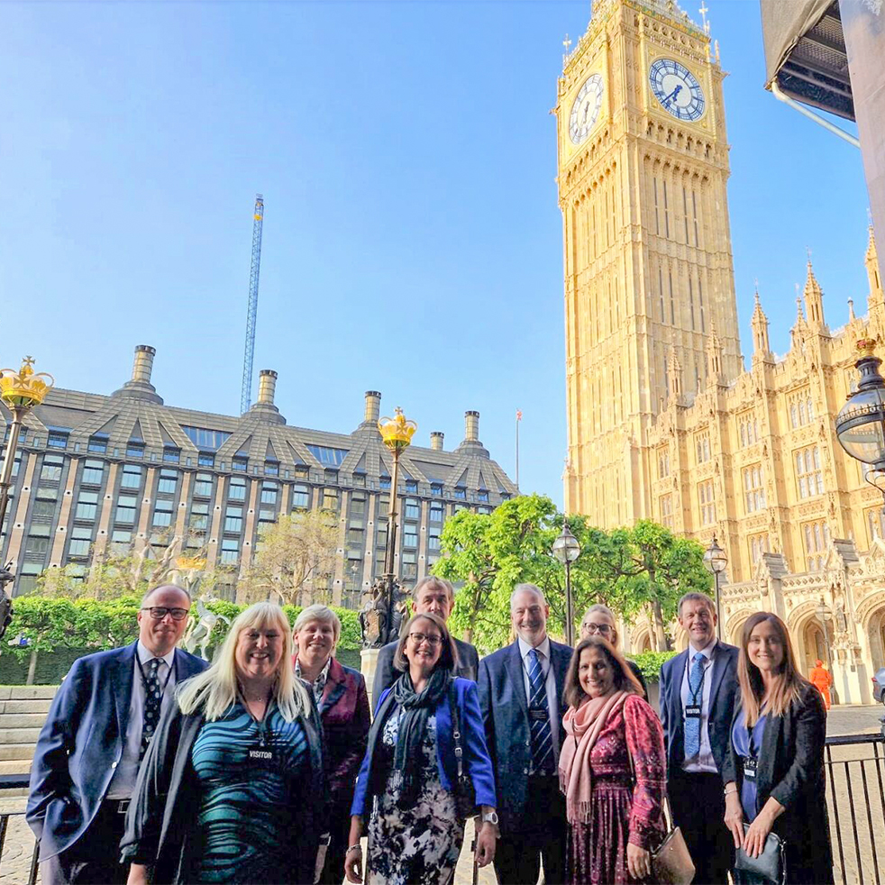 Group of staff stood outside the big ben in London