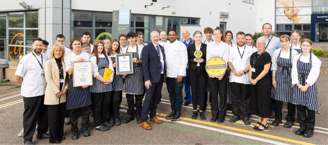 Students and staff celebrate winning an award outside the college restaurant