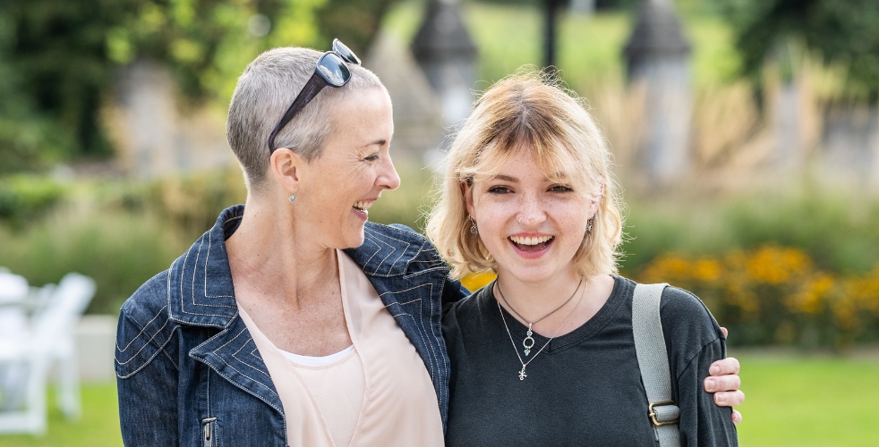 Parent and student smiling together