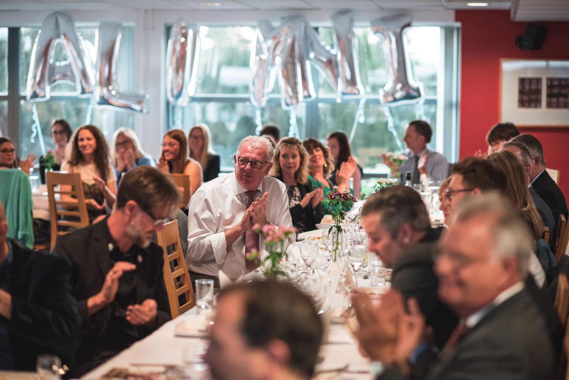 Image of alumni clapping as they attend a dinner in the @34 restaurant in May 2019.