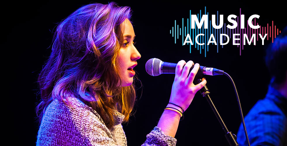 Female music student holding microphone performing