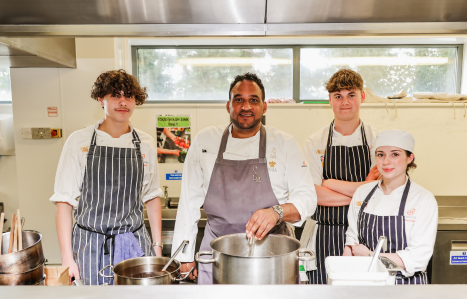 Michael Caines cooks in the kitchen with three students