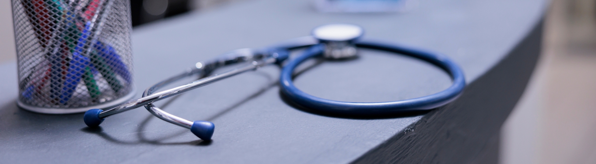 Medical equipment on desk top with pens