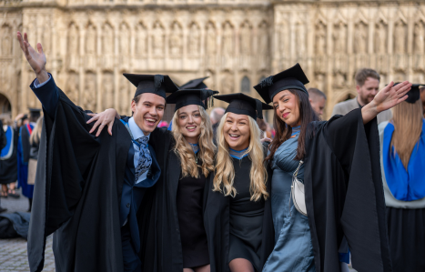 A group of graduates celebrate outside Exeter Cathedral