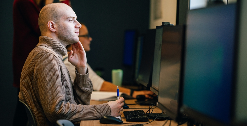 A student looking at a computer screen 