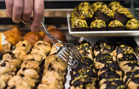 baker picking up a traditional italian pastry