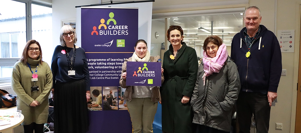 Exeter College and Job Centre teams stood together in front of Career Builders sign