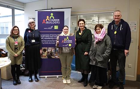 Exeter College and Job Centre teams stood together in front of Career Builders sign