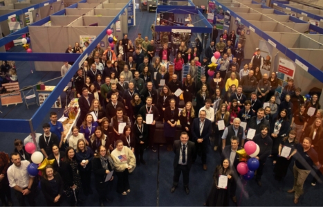 A large group shot looking down into the Expo and everyone looking up at the camera