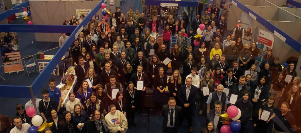 A large group shot looking down into the Expo and everyone looking up at the camera