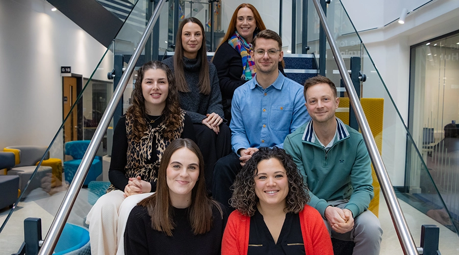 The College Advisors team sat on the stairs smiling