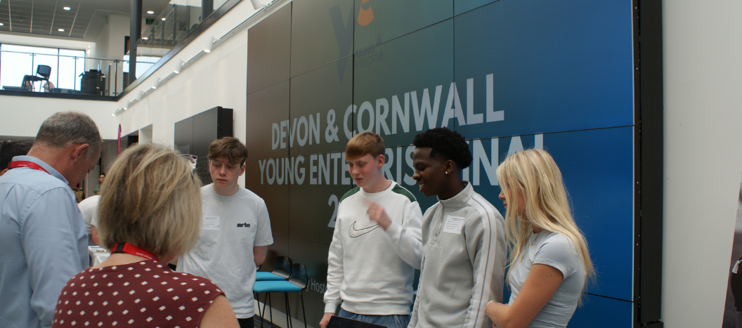 Students from Truro College talking to judges at Young Enterprise Devon Company Programme Final