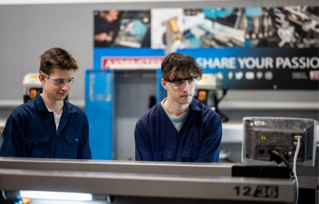 Two engineering students operating machinery