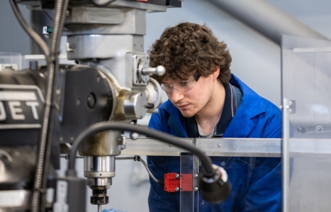 Engineering student looking at machinery