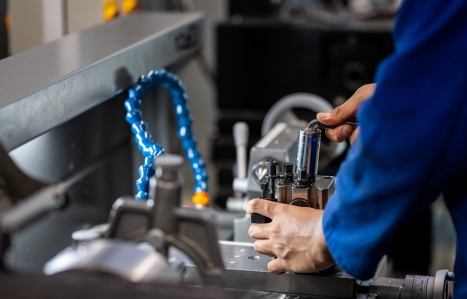 Close up of students hands working on machinery