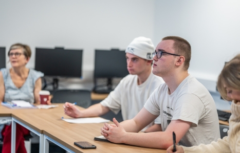 students in a classroom focusing on the teacher