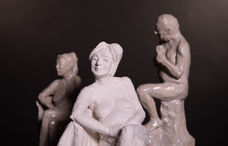 sculptures against a black background