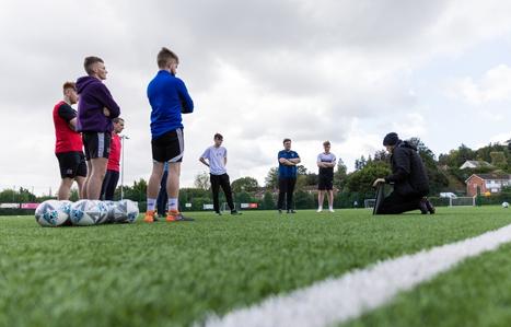 Students on a football pitch