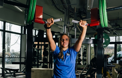 Student using gym equipment