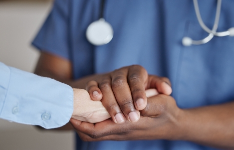 hands being held in a medical setting