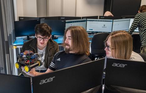 students looking at computing components