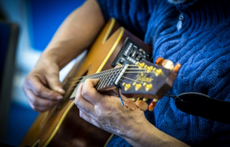 close image of a guitar being played