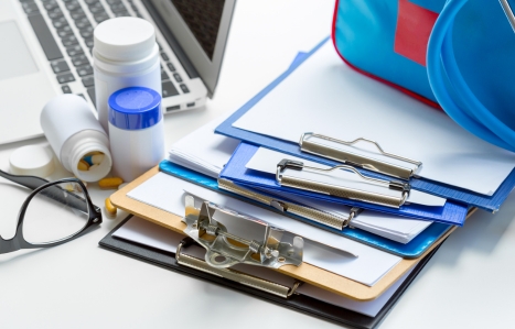Stethoscope lying on medical form on clipboard