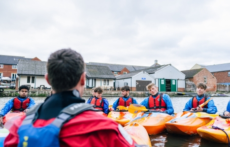 Group of Haven Banks students sat in kayaks at Exeter Quay