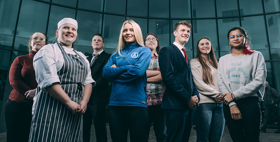 Group shot of students dressed in work clothing for desired career paths