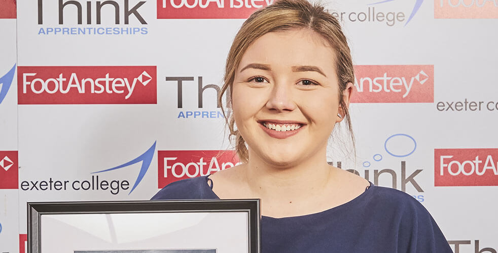Close up of apprenticeship student with award
