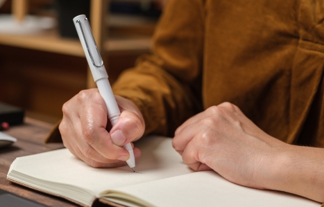 close up woman hand writing on notebook
