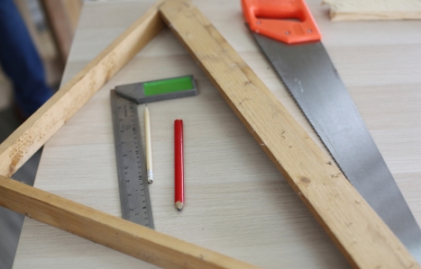 Carpenter grinding joinery product with carvings, finishing woodwork at the carpentry manufacturing