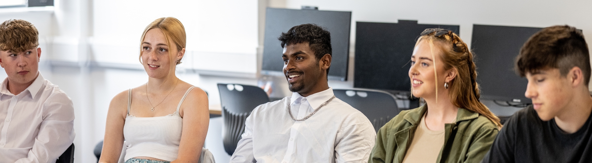 Students smiling whilst doing class work