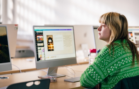 Student at a screen looking up in a class