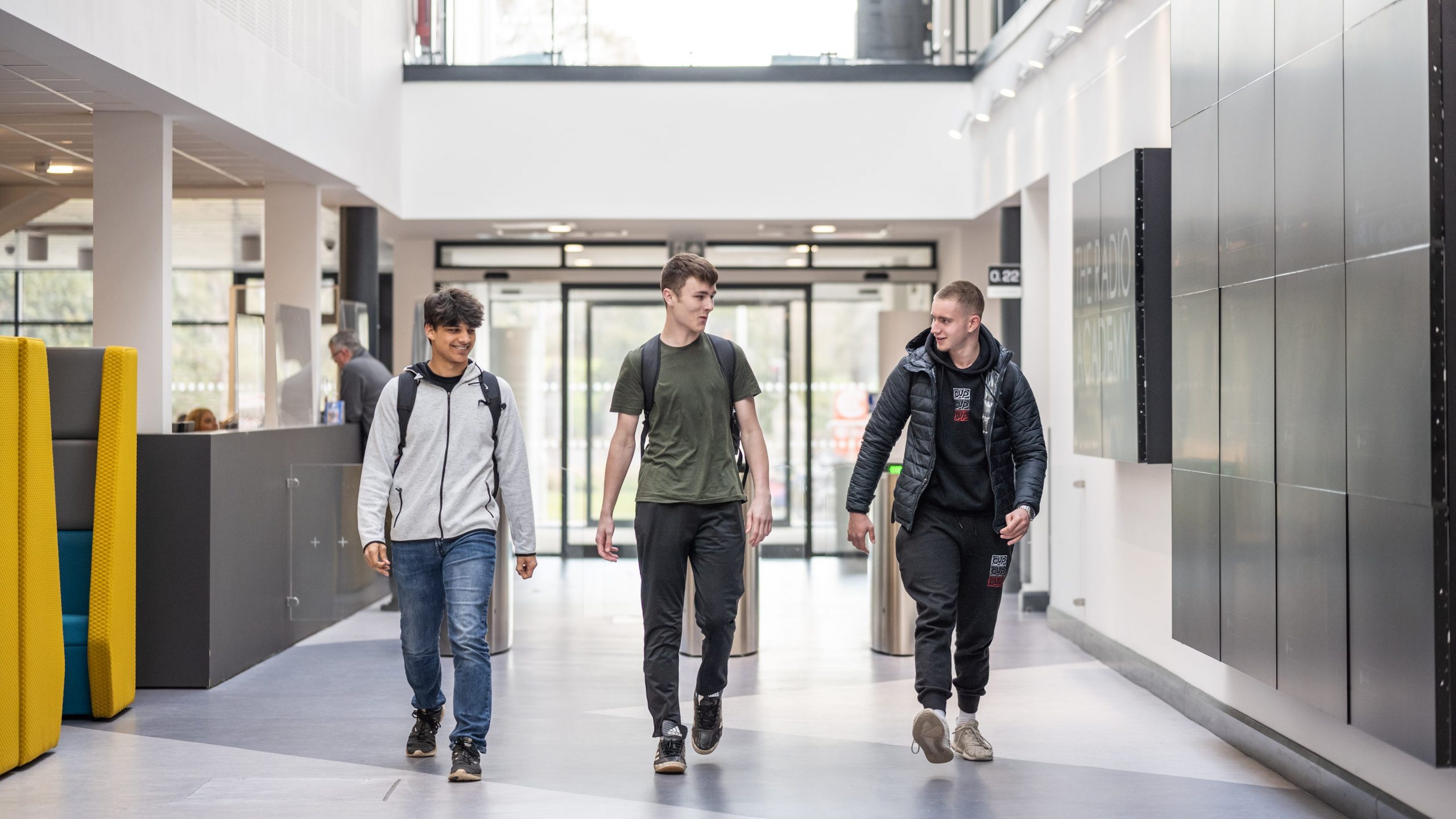 Three students walking through the IoT doors