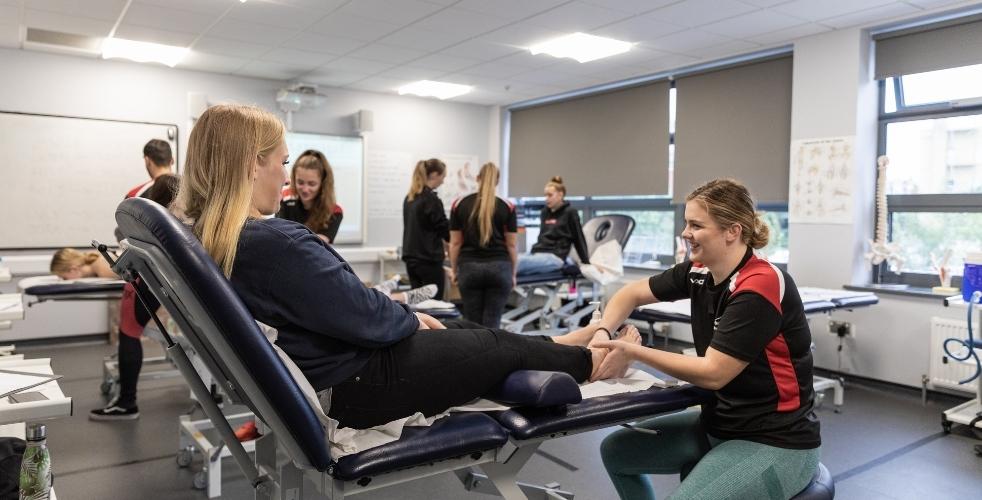 Students practising for their sports therapy degree