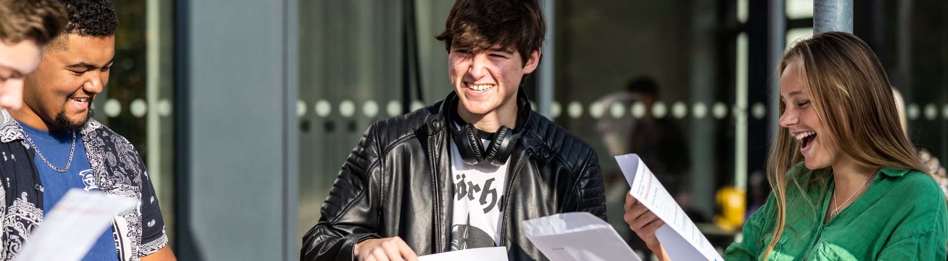 Group of smiling students opening their results