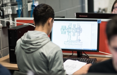 Over the shoulder of a student working on a computer