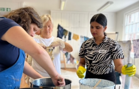 Three adult learners cooking together